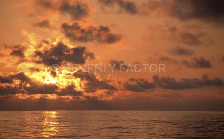 Islands;sunsets;sky;clouds;colorful;sun;yellow;water;red;Galapogos Island